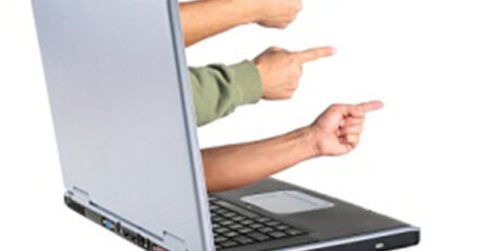 finger pointing from a laptop